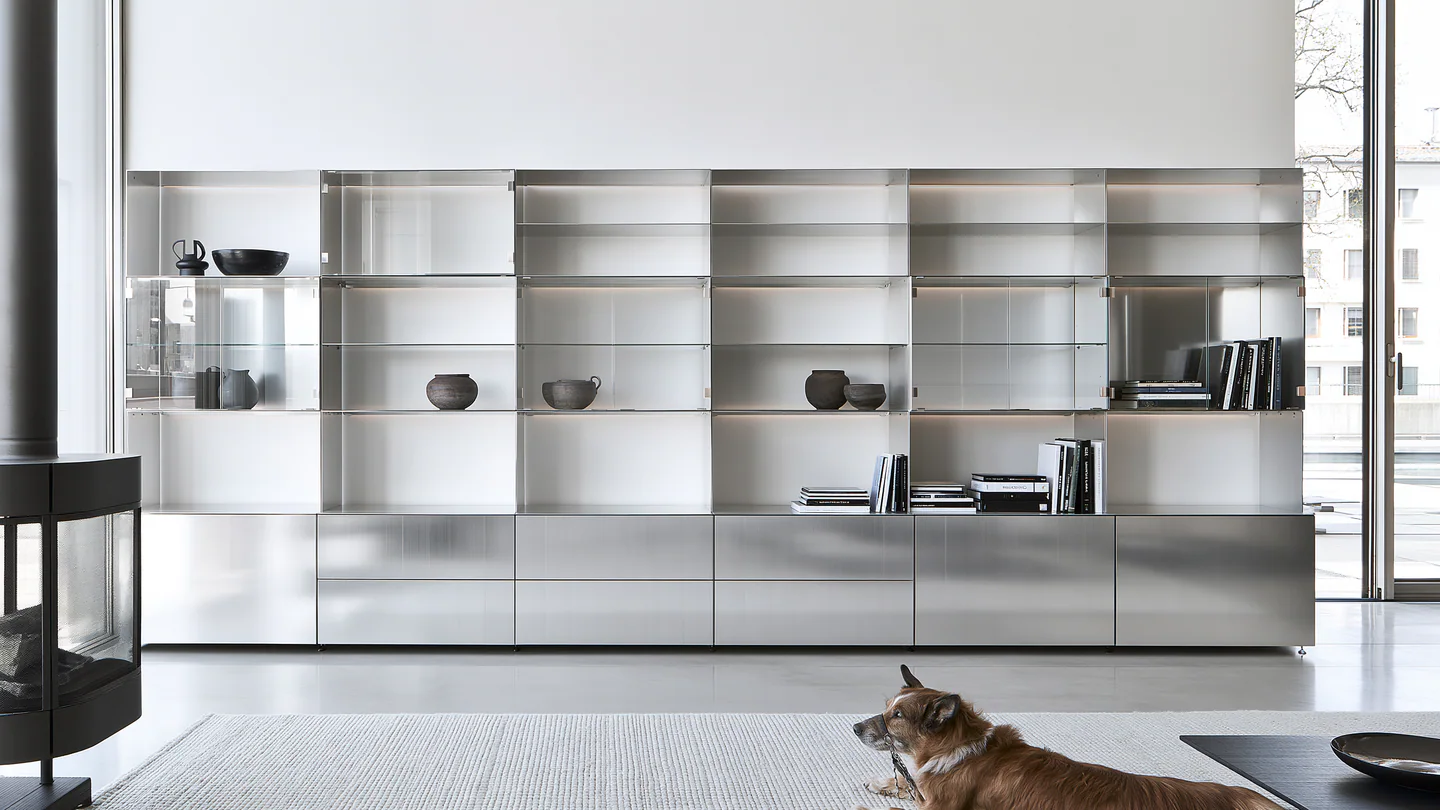 A silver modular aluminum display wall, shown as a wide room view
