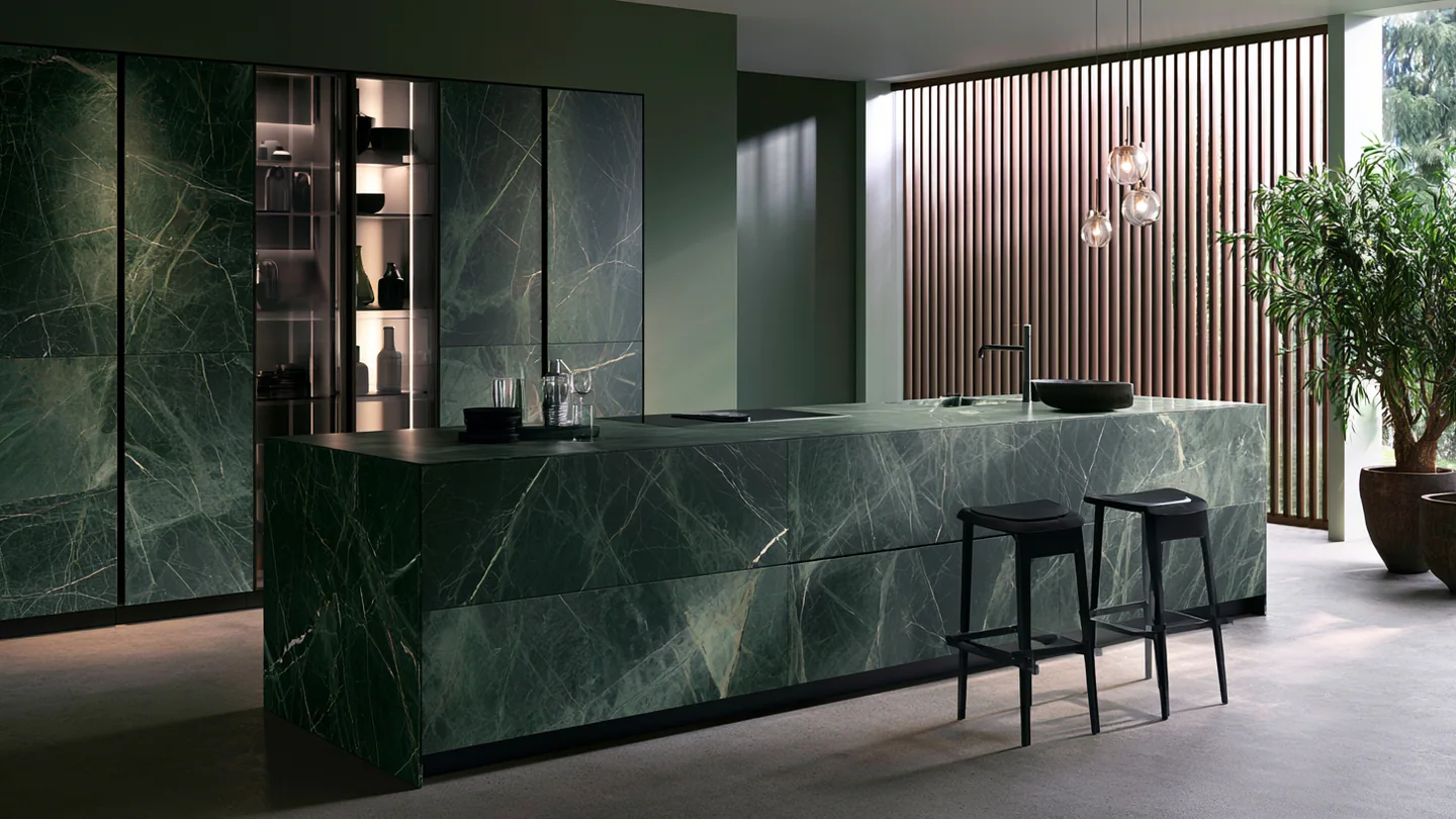 A deep green sintered stone kitchen, shown as a wide room view