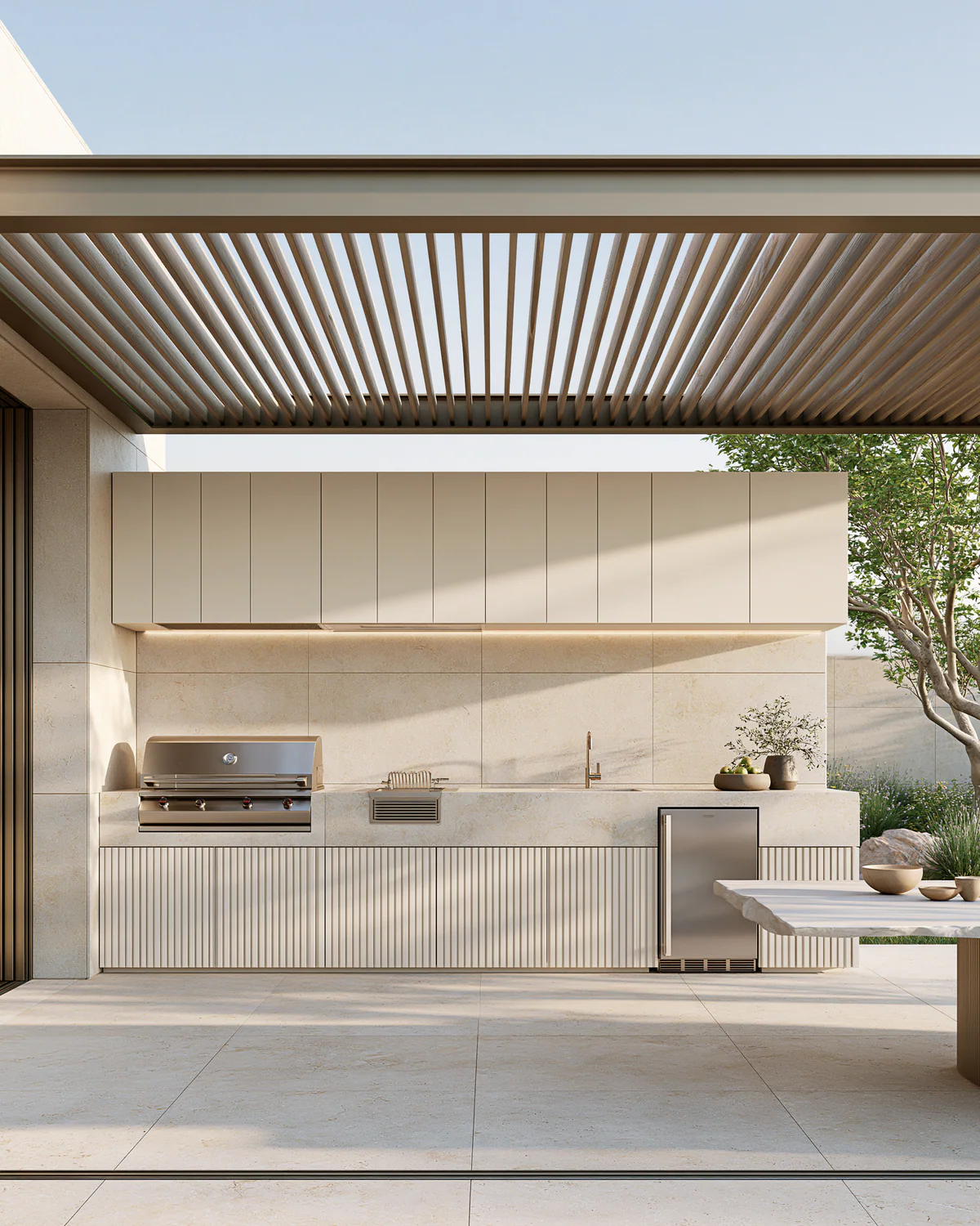 A warm white sintered stone outdoor kitchen beneath a pergola, shown as an associated cabinet detail