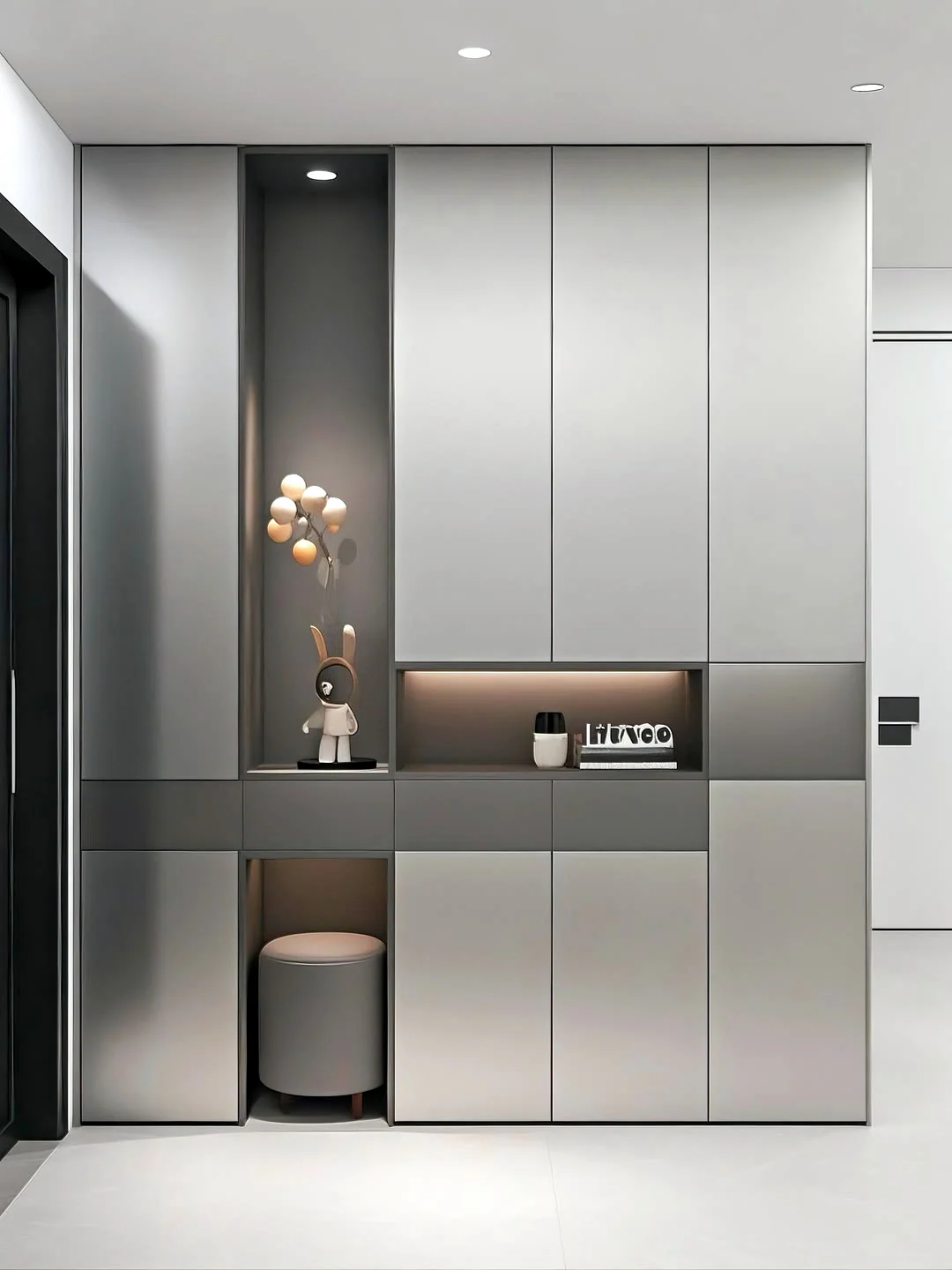 Pale full-height entry cabinets with charcoal display niches, drawers and a low open bay